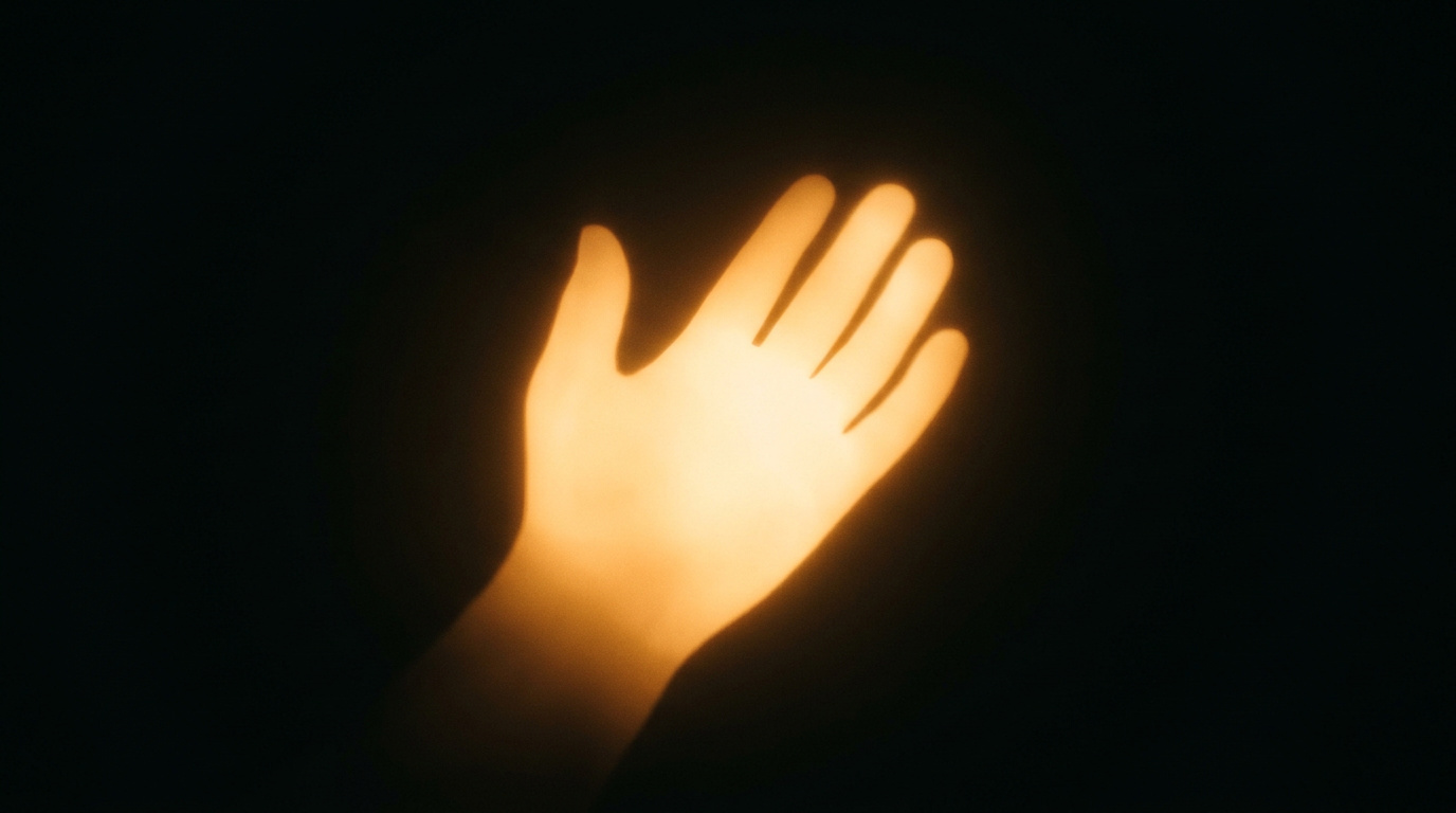 Warm glowing hand silhouette offering support