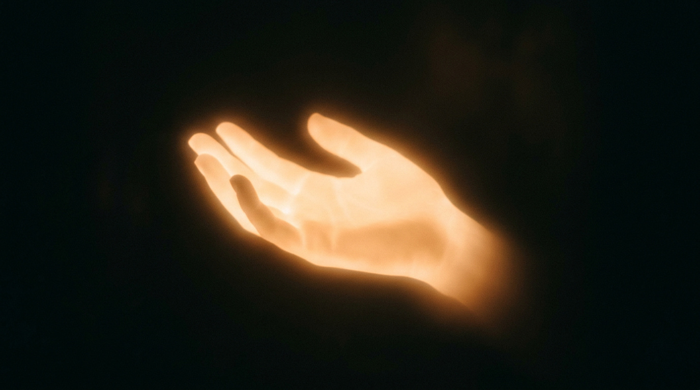 Warm glowing hand silhouette offering support